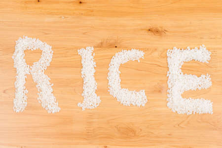 rice on wooden board form a pattern of word  rice の写真素材