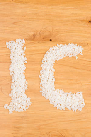 rice on wooden board form a pattern of word  icの写真素材