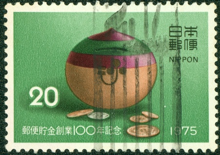 JAPAN - CIRCA 1975  stamp printed by Japan shows Japanese money box, circa 1975のeditorial素材