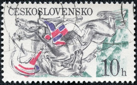 CZECHOSLOVAKIA - CIRCA 1978  A stamp printed in the Czechoslovakia, Pardubice Steeplechase, shown Falling horses and jockeys at fence, circa 1978の写真素材