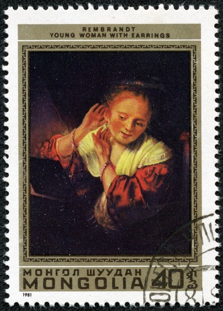 USSR - CIRCA 1973  A Stamp printed in USSR shows the  Woman Trying on Earrings , by Rembrandt  1606-1669 , from the series  Foreign paintings in Russian museums , circa 1973のeditorial素材