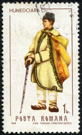 ROMANIA - CIRCA 1968  A stamp printed in the Romania, shows regional folk costumes, a man from Hunedoara, circa 1968のeditorial素材