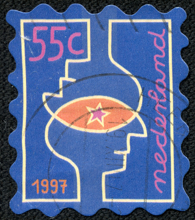 NETHERLAND - CIRCA 1997  A Christmas Stamps printed in Netherland shows Overlapping heads, circa 1997のeditorial素材