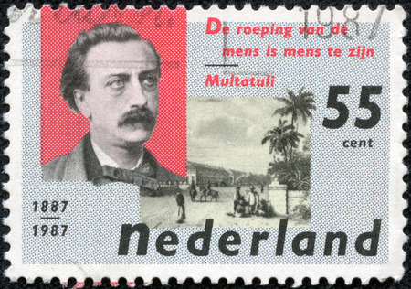 NETHERLANDS - CIRCA 1987: a stamp printed in the Netherlands shows Eduard Douwes Dekker and De Harmonie Club, Batavia, circa 1987のeditorial素材
