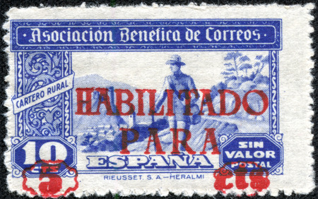 SPAIN - CIRCA 1946: A stamp printed in Spain shows image of a man walking in a rural area, series, circa 1946のeditorial素材