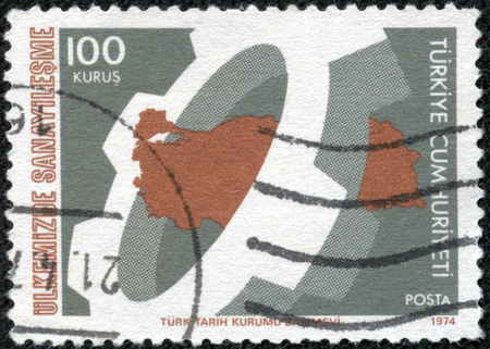 TURKEY- CIRCA 1974: stamp printed by Turkey, shows cogwheel and map of Turkey, circa 1974のeditorial素材