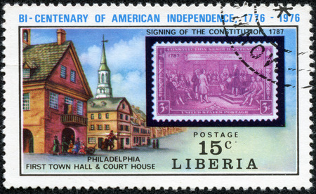 LIBERIA - CIRCA 1976  A stamp printed in Liberia, shows US postage stamp in 1937 signing of the constitution, Philadelphia First Town Hall and Court House, circa 1976の写真素材