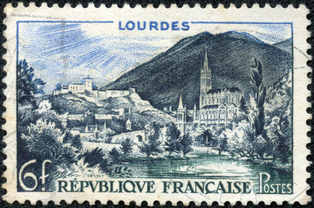 FRANCE - CIRCA 1958  A stamp printed in France shows Lourdes, circa 1958のeditorial素材