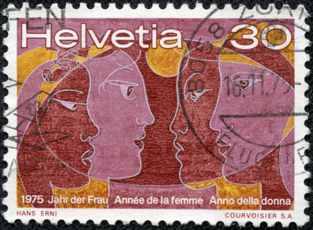 SWITZERLAND - CIRCA 1975  A post stamp printed in Switzerland shows canvas of Hans Erni Swiss painter, devoted the year of woman, circa 1975のeditorial素材