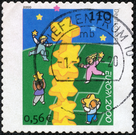 GERMANY - CIRCA 2000  a stamp printed in the Germany shows Children and Stars, circa 2000のeditorial素材
