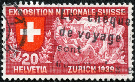 SWITZERLAND - 1939: stamp printed in Switzerland shows coat of arms of confederation, family listen to Senn Alm, poet, symbolizing spiritual life, Switzerland national exhibition, circa 1939のeditorial素材