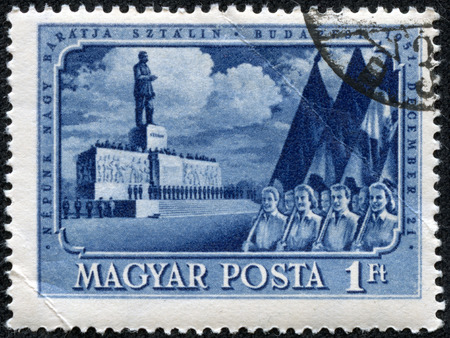 HUNGARY - CIRCA 1951: A Stamp printed in Hungary shows May Day demonstration in Budapest against the backdrop of the monument to Joseph Stalin, circa 1951のeditorial素材