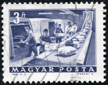 HUNGARY - CIRCA 1964: a stamp printed in the Hungary shows P.O. Parcel Conveyor, circa 1964のeditorial素材