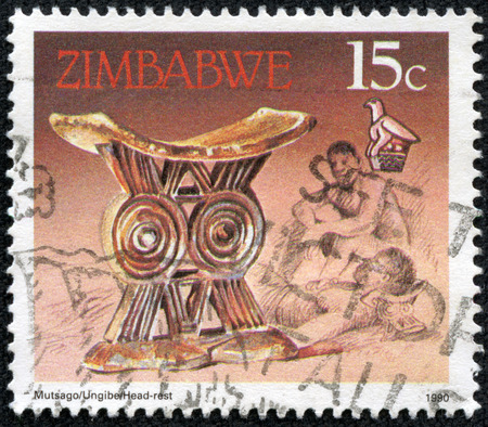 ZIMBABWE - CIRCA 1990: A stamp printed in Zimbabwe shows image of a Antique gold headrest, series, circa 1990の写真素材