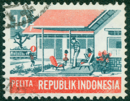 INDONESIA - CIRCA 1969: A stamp printed in Indonesia from the \"Five-year Development Plan\" issue shows Modern family (Social Welfare), circa 1969.のeditorial素材