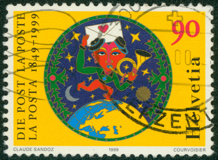 SWITZERLAND - CIRCA 1999: stamp printed by Switzerland, shows Postman Running on Globe, circa 1999のeditorial素材