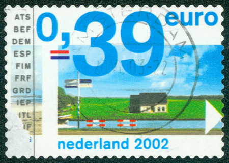 . NETHERLANDS - CIRCA 2002: One rural house The water channel, circa 2002.のeditorial素材