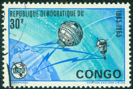 DEMOCRATIC REPUBLIC OF CONGO - CIRCA 1965: A 30 franc stamp from the Democratic Republic of Congo shows image of the Earth and satellites, circa 1965のeditorial素材