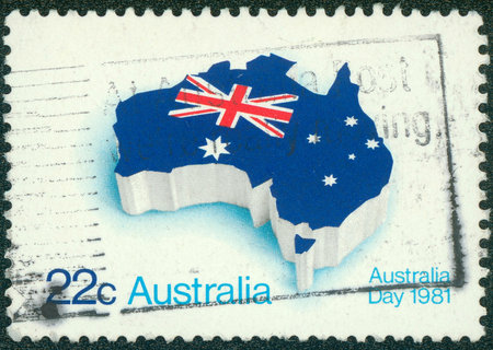 AUSTRALIA - CIRCA 1981: A stamp printed in Australia shows flag of Australia placed in the contour of the continent, circa 1981のeditorial素材