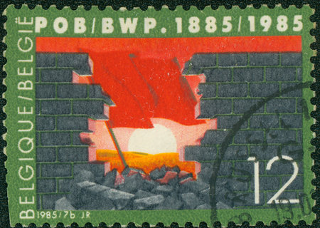 BELGIUM - CIRCA 1985: The broken wall. A red flag against the sun, circa 1985.