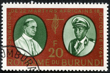 BURUNDI - CIRCA 1964: A stamp printed in Burundi shows Pope Paul and King Mwambutsa IV, Canonization of 22 African Martyrs, circa 1964のeditorial素材