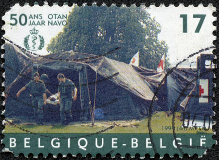 CHONGQING, CHINA - May 10, 2014:stamp printed by Belgium, shows Hospital tent, NATO, circa 1999のeditorial素材
