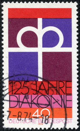 CHONGQING, CHINA - May 21, 2014: A stamp printed in the Germany dedicated to 125th anniversary of the Diaconal Association of the German Protestant Church, circa 1974のeditorial素材