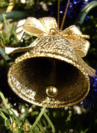 Golden bell decoration on a Christmas treeの写真素材