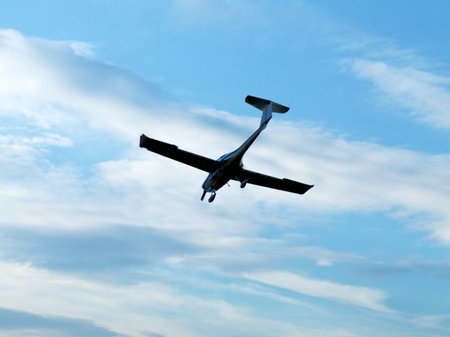 Silhouette of an airplane in the skyの写真素材