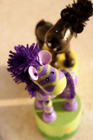 Wooden zebra and horse toys (focus on zebra head)の写真素材