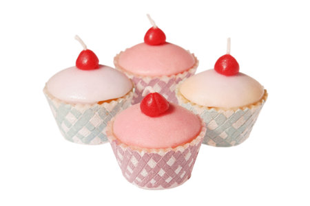 Cupcake shaped candles isolated on whiteの写真素材