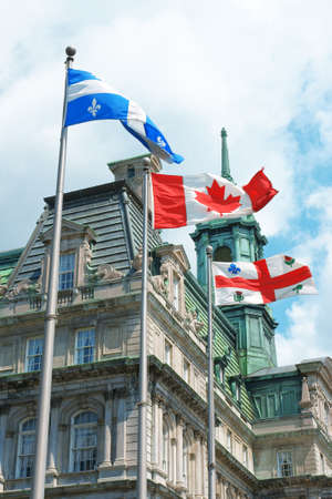 Old Montreal City Hall and Quebec, Canada and city flagの写真素材