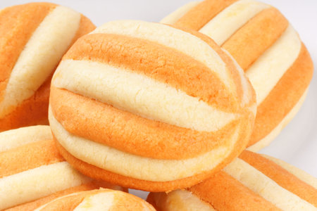 Close-up of some shortcrust pastry biscuits over a white plate 