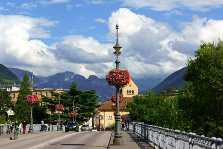 Bolzano, Italy - August 21, 2014: Ponte Talvera bridge that leads to downtown Bolzano crossing Talvera river. It was built in 1900 by austrian Waagner-Biro company to connect the old town to its new quarters Gries and SanQuirino. A lot of people around. Bのeditorial素材