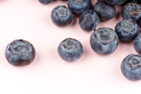Close-up of some blueberries over a pink paper background. Selective soft focus.の写真素材