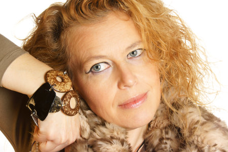 Studio portrait of an adult blond caucasian woman with blue eyes over a white background.の写真素材