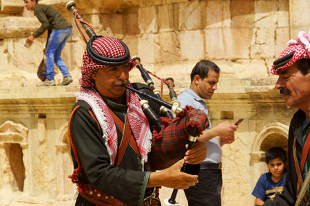 Jerash, Jordan - May 1, 2018: Jordanian bagpipe players in the north roman theater of the archeological site of Jerash near Amman in Jordan.のeditorial素材