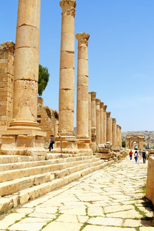 Jerash, Jordan - May 1, 2018: cardo maximus, the main street in the archeological site of Jerash, the ancient city of Gerasa, 50 km far from the capital Amman in Jordan. Some people around.のeditorial素材