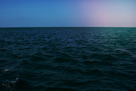 Blue sea and clouds on sky. Seascape with sea horizon and almost clear deep blue sky. Wallpaper, Background.の写真素材