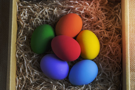 Colorful easter eggs in carton top view on white background. Colorful eggs.
