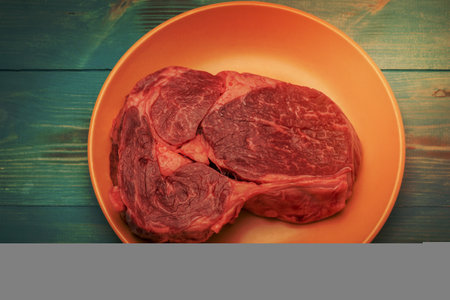 Beef steak on a beige plate on a turquoise aged background. Food photography, meat.の写真素材