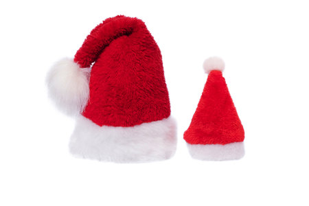 Celebrating Christmas or New Year. Red with white santa hat christmas concept. Small and big santa hat.の写真素材