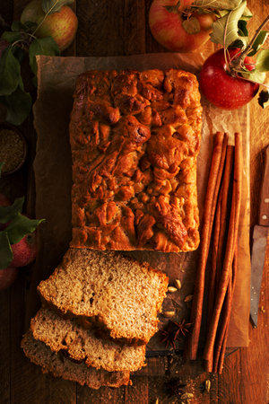 Apple bread rustic style with freshy picked apples and cinnamon, fall baking concept overhead shotの写真素材