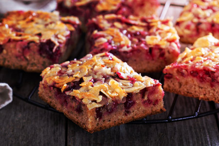 Berry cake bars with caramel almond topping  on a cooling rackの写真素材