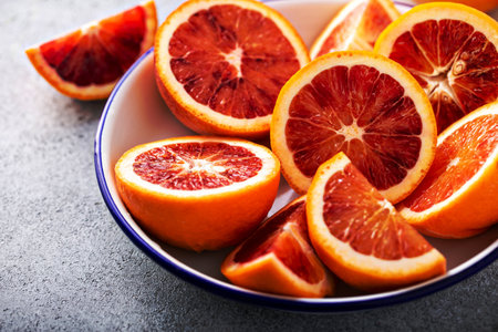 Blood oranges cut into half, juicy winter citrusの写真素材