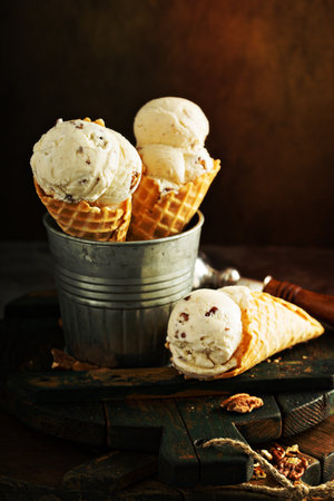 Butter pecan ice cream in waffle cones on dark backgroundの写真素材