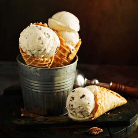 Butter pecan ice cream in waffle cones on dark backgroundの写真素材