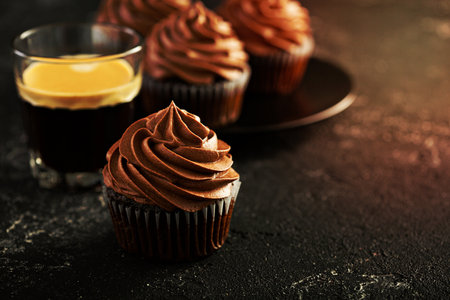 Chocolate coffee cupcakes served with espresso in a glassの写真素材