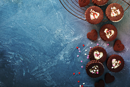 Chocolate cookie sandwiches with cream cheese filling for Valentines Day with sprinklesの写真素材