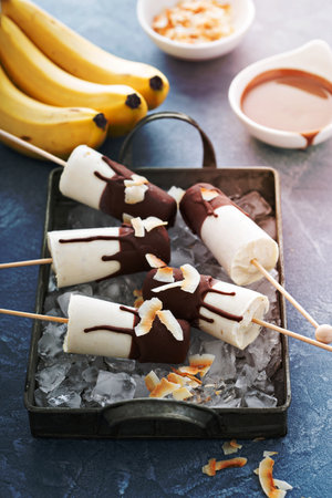 Banana and chocolate homemade ice cream with yogurt and coconutの写真素材